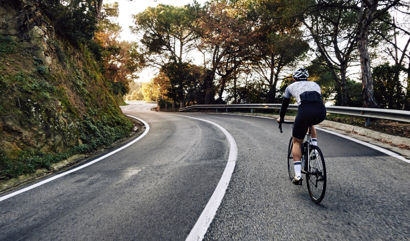 Cyclist man riding a bike on the road