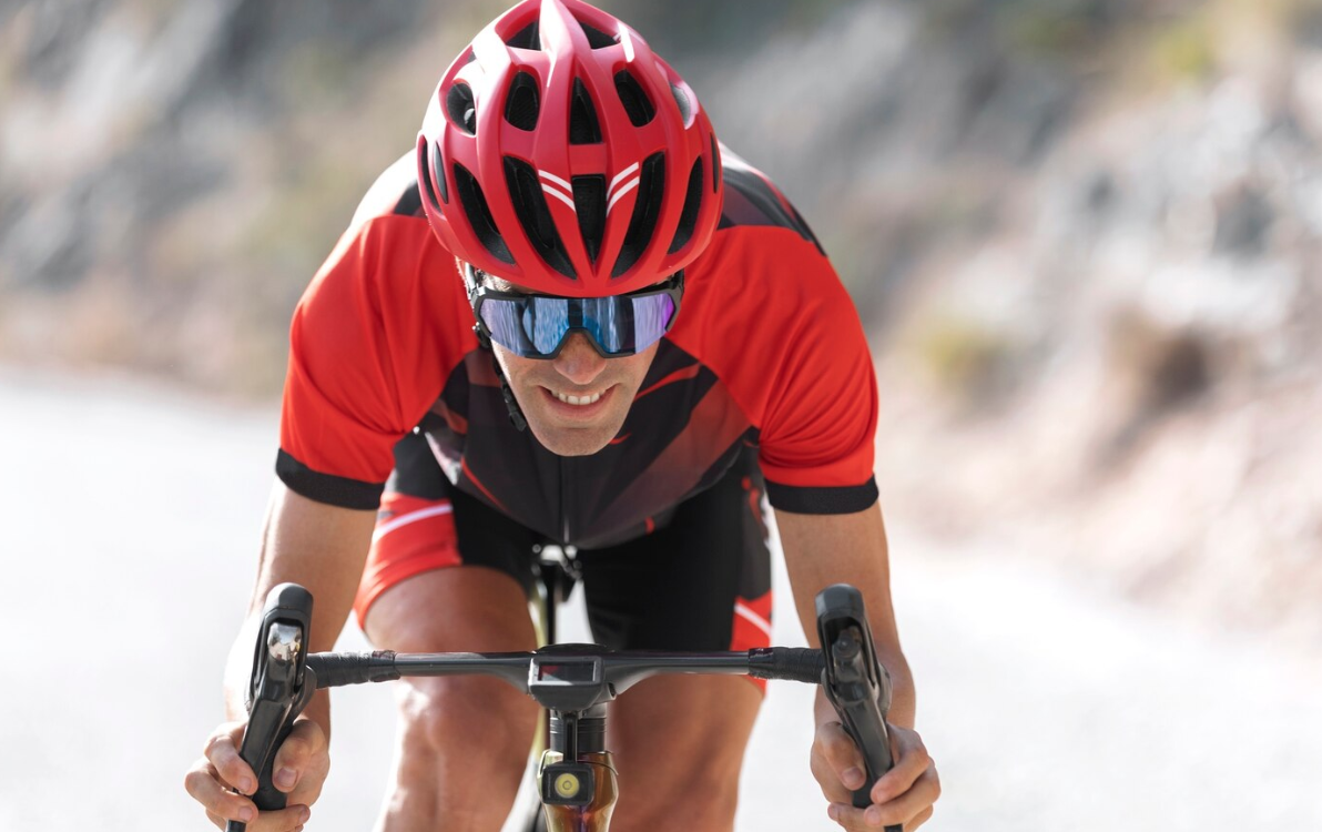 Man cycling outdoors with his bike and helmet
